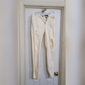 Cream color skinny jeans with rips in legs(stretch denim size 11)